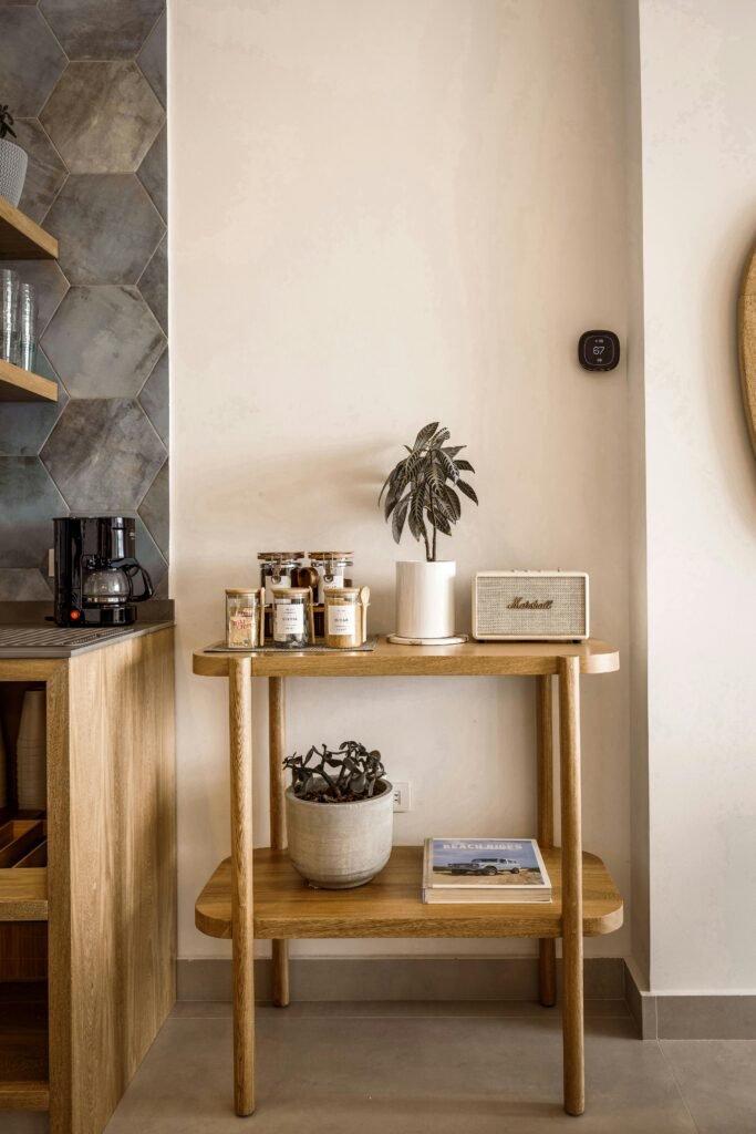 A stylish kitchen corner with wood shelves, coffee maker, and decor on display.
